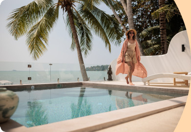 Woman walking next a pool on holidays