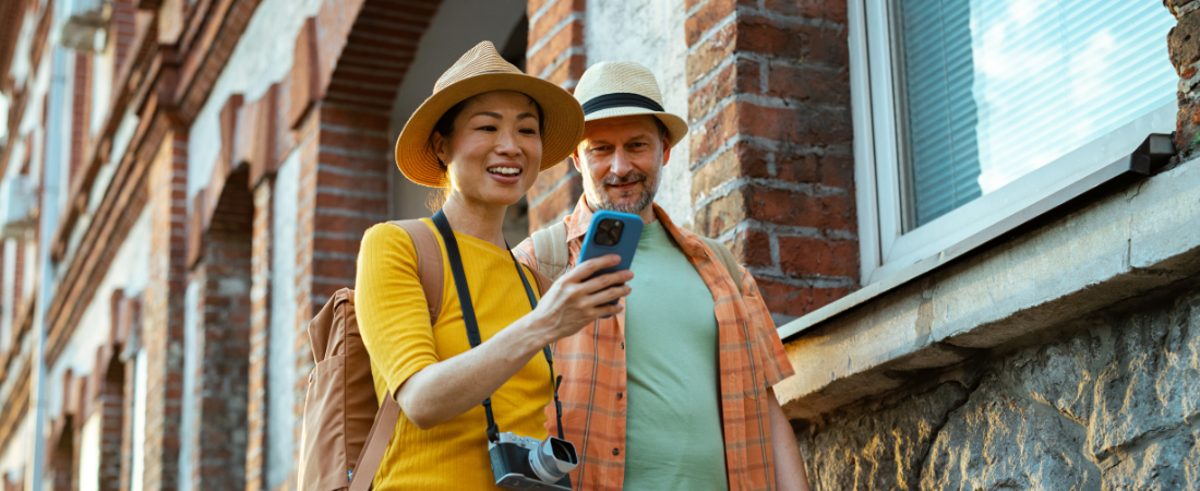 Traveller couple using Cover-More app during their trip