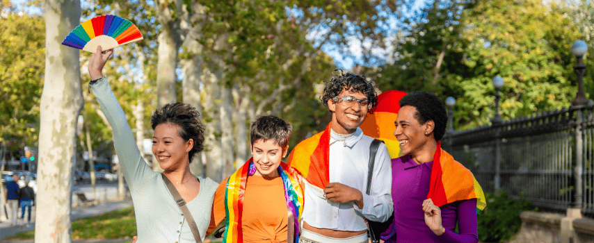 Group of travellers with rainbow flags, exercising LGBTQIA+ travel safety