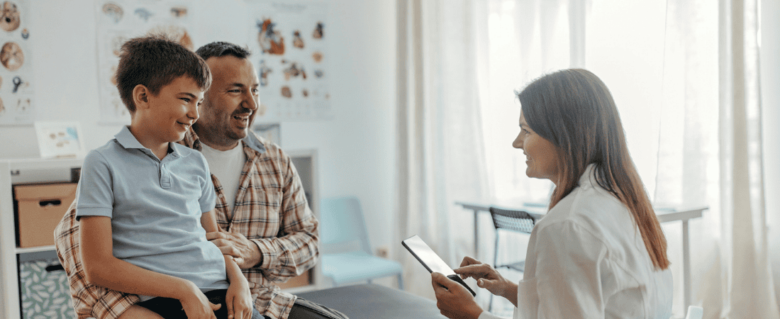 Father and young son visiting the doctor while travelling