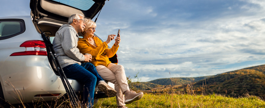 Senior travellers on holiday calling for help after being in a car accident 