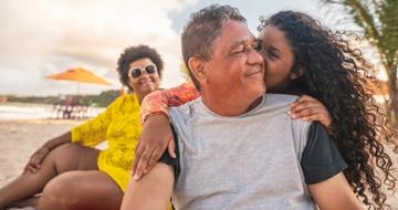 Happy daughter hugging her dad on holiday 